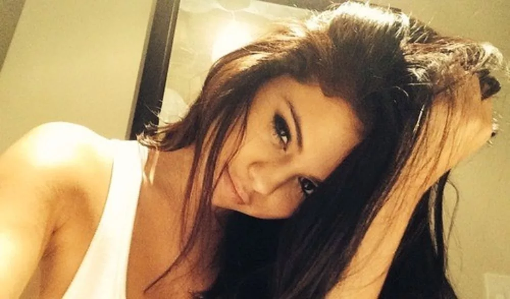 sexy selena gomez taking a selfie with her head tilted